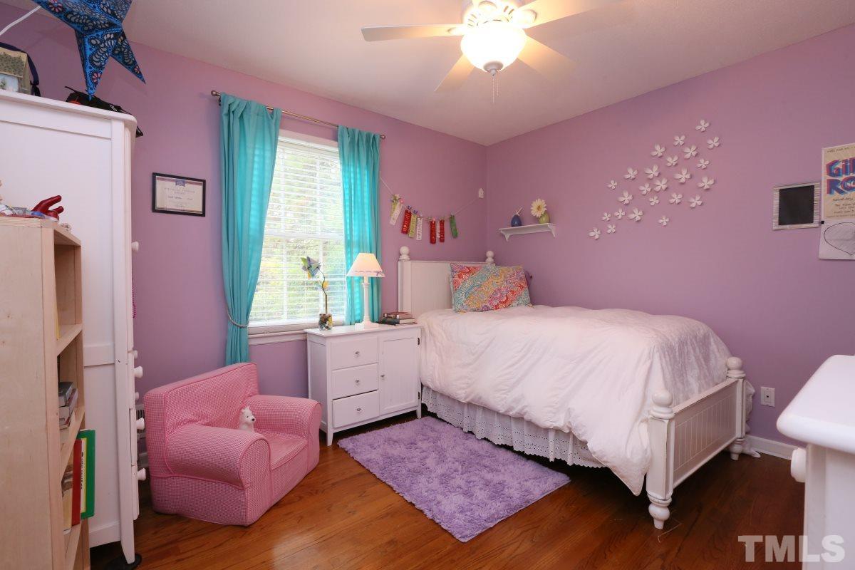 1013 Deerfield Road Raleigh, NC 27609 - Photo 20 of 25 a bedroom with a bed and a chandelier