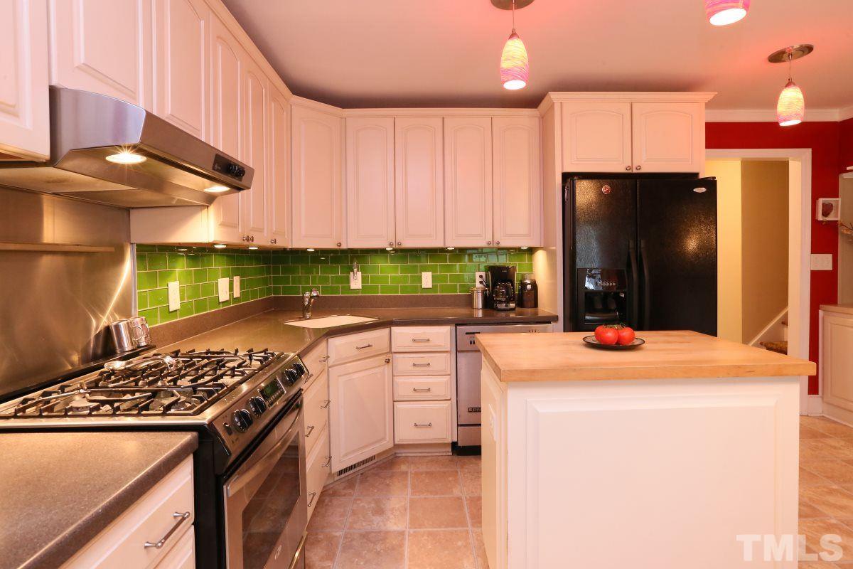 1013 Deerfield Road Raleigh, NC 27609 - Photo 3 of 25 a kitchen with a stove a sink and a refrigerator