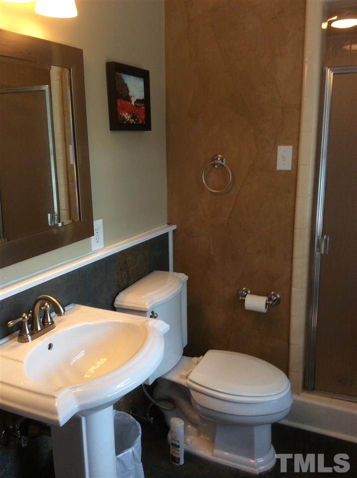1013 Deerfield Road Raleigh, NC 27609 - Photo 21 of 25 a bathroom with a sink a toilet and a mirror