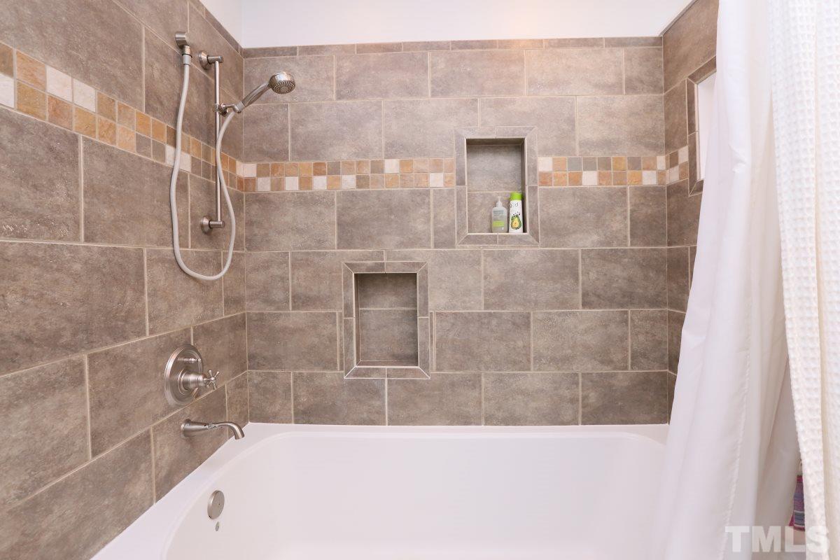 1013 Deerfield Road Raleigh, NC 27609 - Photo 7 of 25 a bathroom with a bathtub and shower