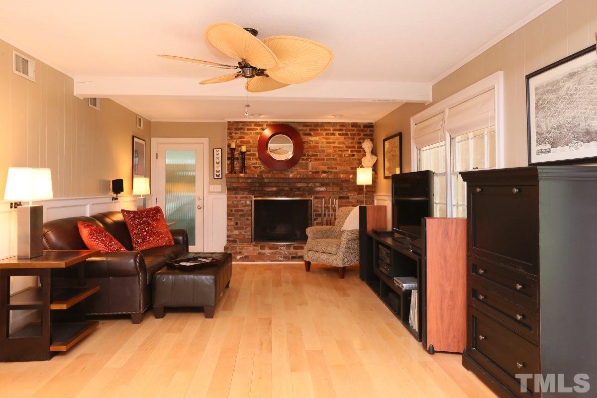 1013 Deerfield Road Raleigh, NC 27609 - Photo 8 of 25 a living room with furniture and a fireplace