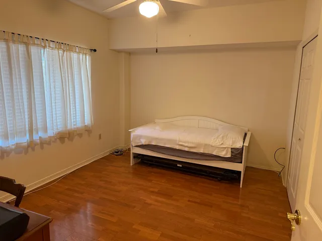 a bedroom with a bed and a window