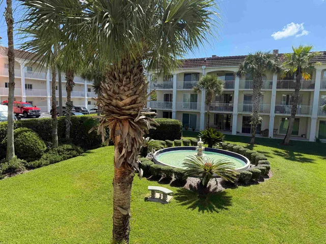 a house view with a swimming pool and sitting space