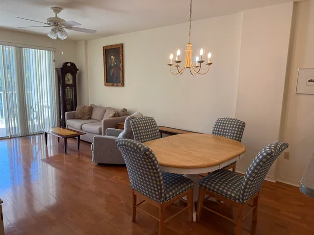 a view of a dining room with furniture wooden floor and chandelier