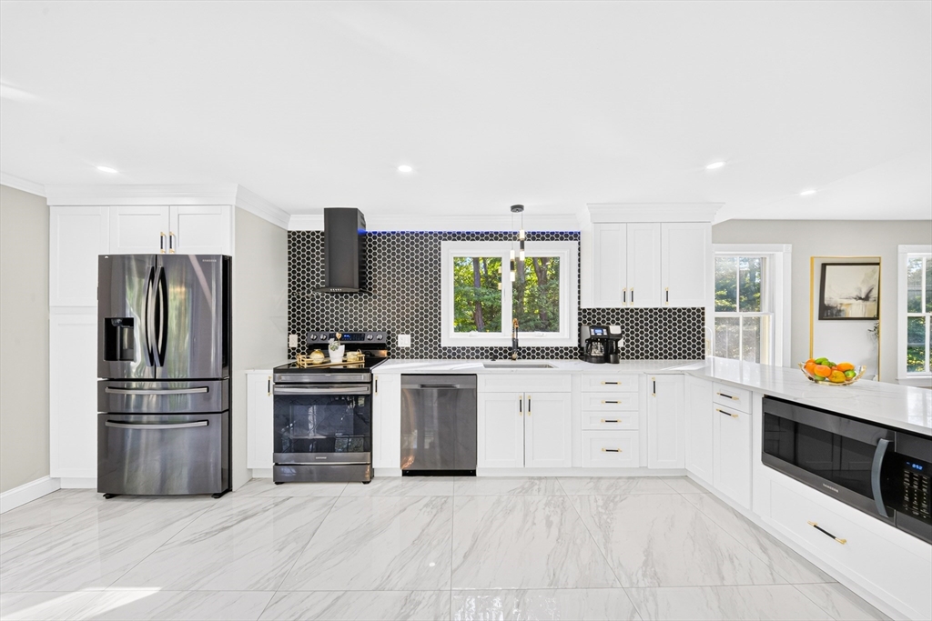 24 Miller Road Wilmington, MA 01887 - Photo 4 of 40 a kitchen with a refrigerator and a stove top oven