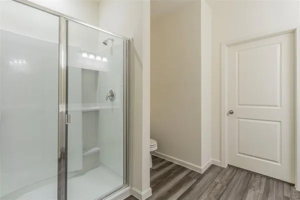 a bathroom with a glass shower door