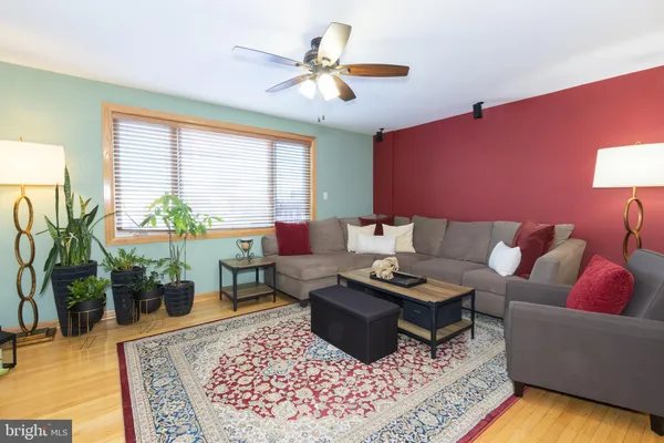a living room with furniture a rug and a large window
