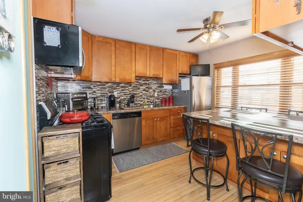 a kitchen with stainless steel appliances granite countertop a stove and cabinets