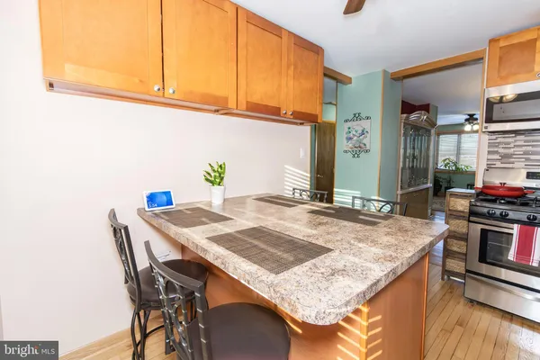 a dining table with chairs and kitchen