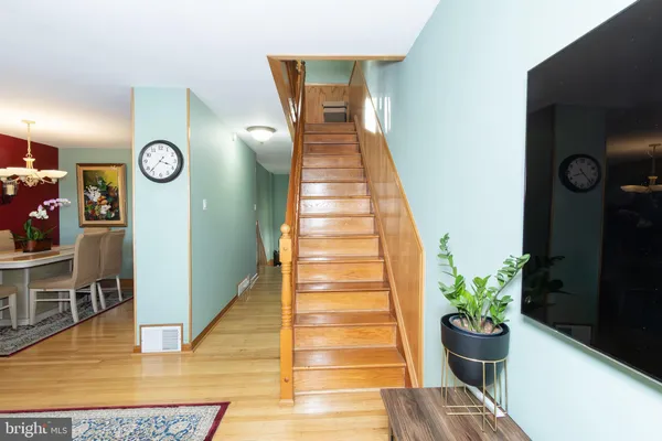 a view of entryway and hall with wooden floor