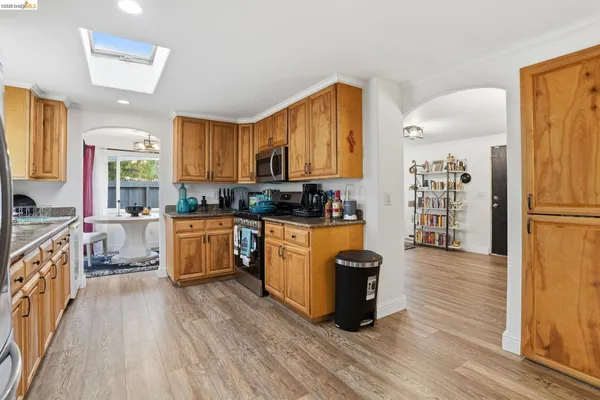 a kitchen with stainless steel appliances a refrigerator sink and cabinets