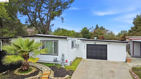 a front view of house with yard outdoor seating and barbeque oven