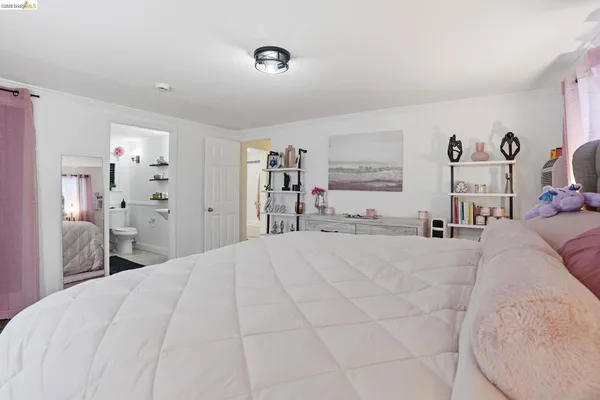 a bed room with a bed and a large mirror