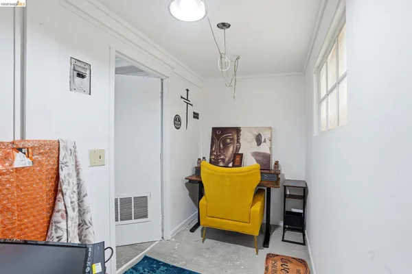 a view of a bedroom with baby bed and windows