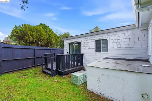 a backyard of a house with table and chairs