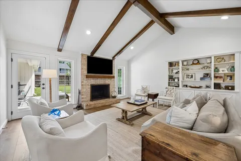 a living room with furniture fireplace and a flat screen tv