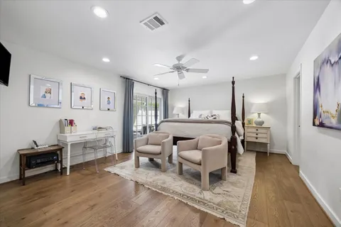 a bedroom with furniture and a wooden floor
