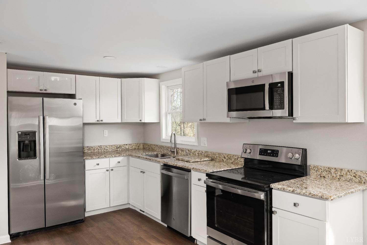 3936 Goodview Road Goodview, VA 24095 - Photo 15 of 29 a kitchen with cabinets stainless steel appliances and a sink
