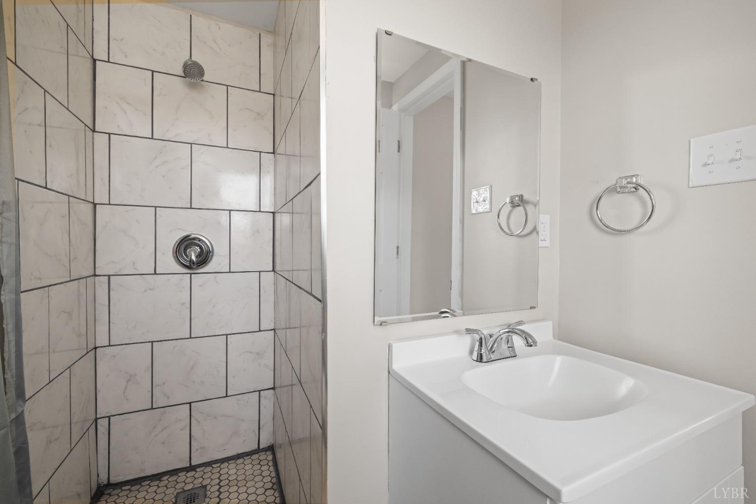 3936 Goodview Road Goodview, VA 24095 - Photo 25 of 29 a bathroom with a sink shower and a mirror