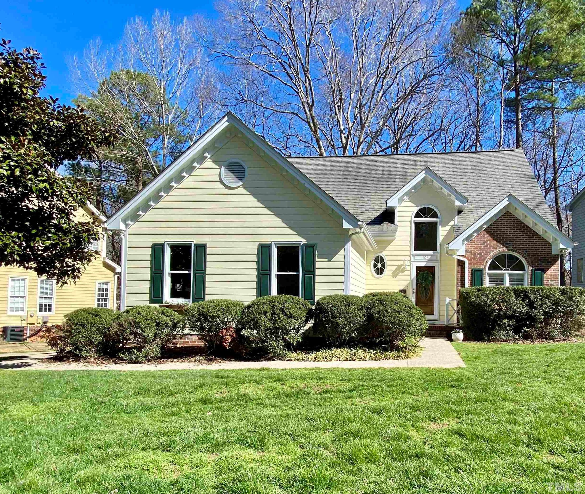 a front view of house with yard and green space