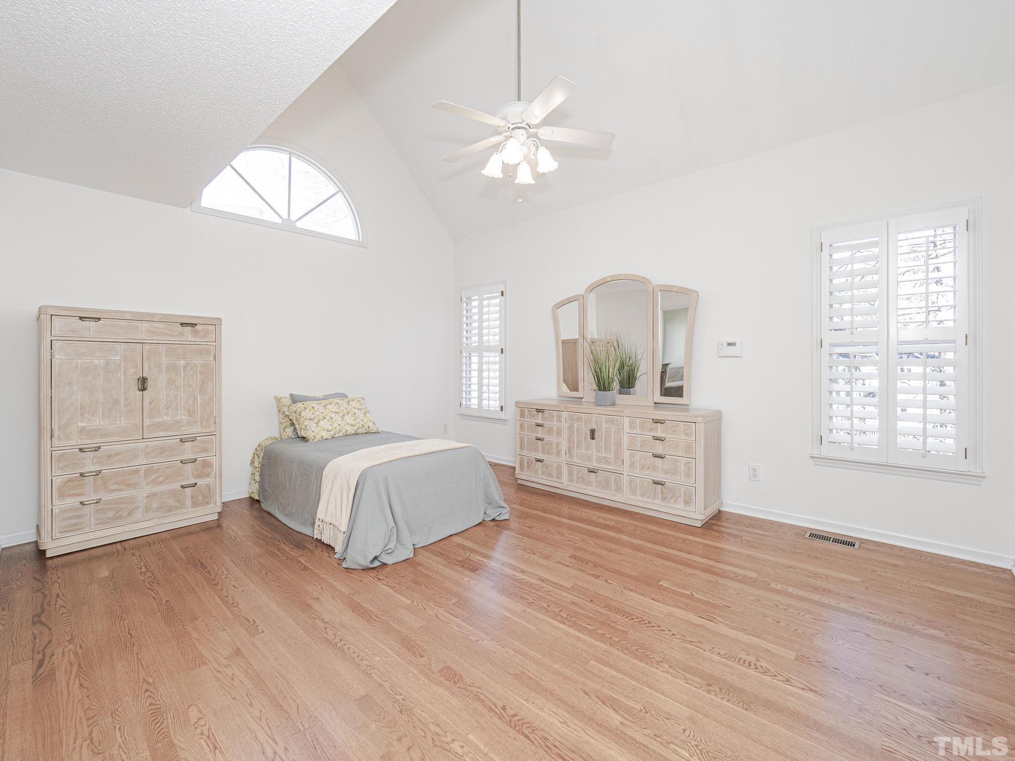106 Kingsmill Road Cary, NC 27511 - Photo 17 of 31 a spacious bedroom with a bed and a dresser