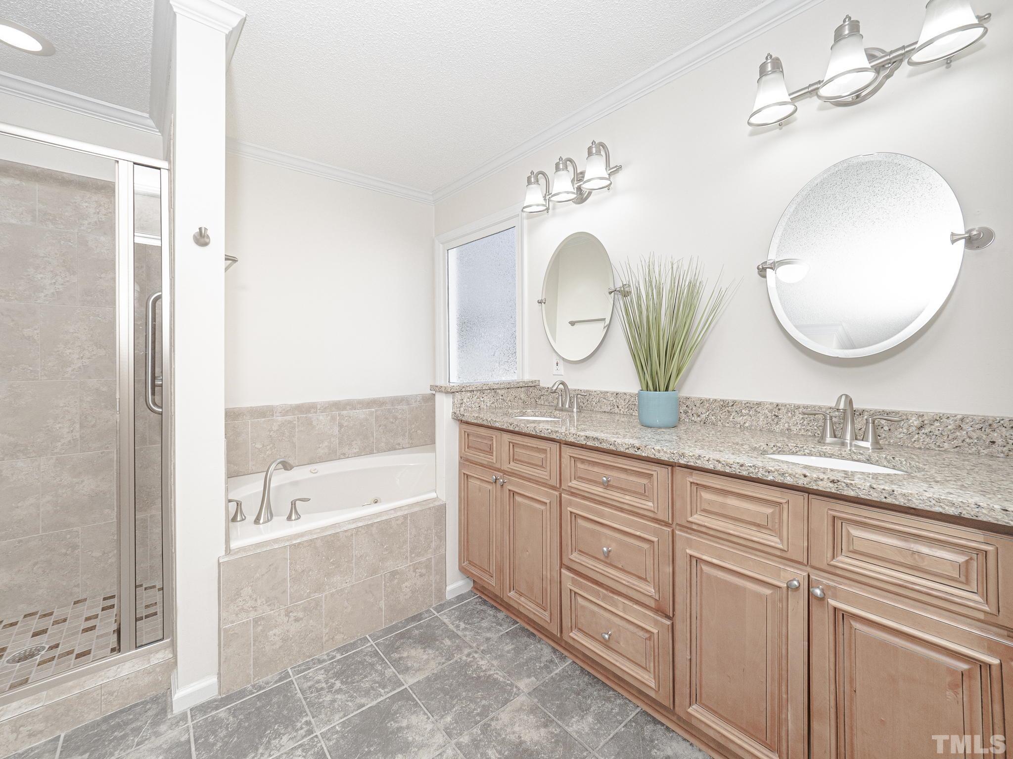 106 Kingsmill Road Cary, NC 27511 - Photo 19 of 31 a bathroom with a granite countertop double vanity sink and a mirror