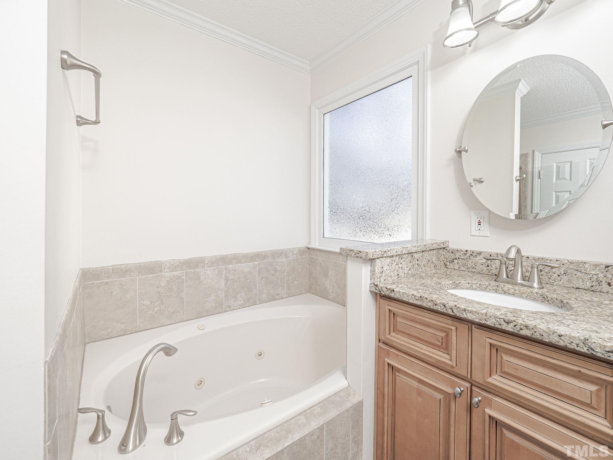 106 Kingsmill Road Cary, NC 27511 - Photo 20 of 31 a bathroom with a bathtub and a sink