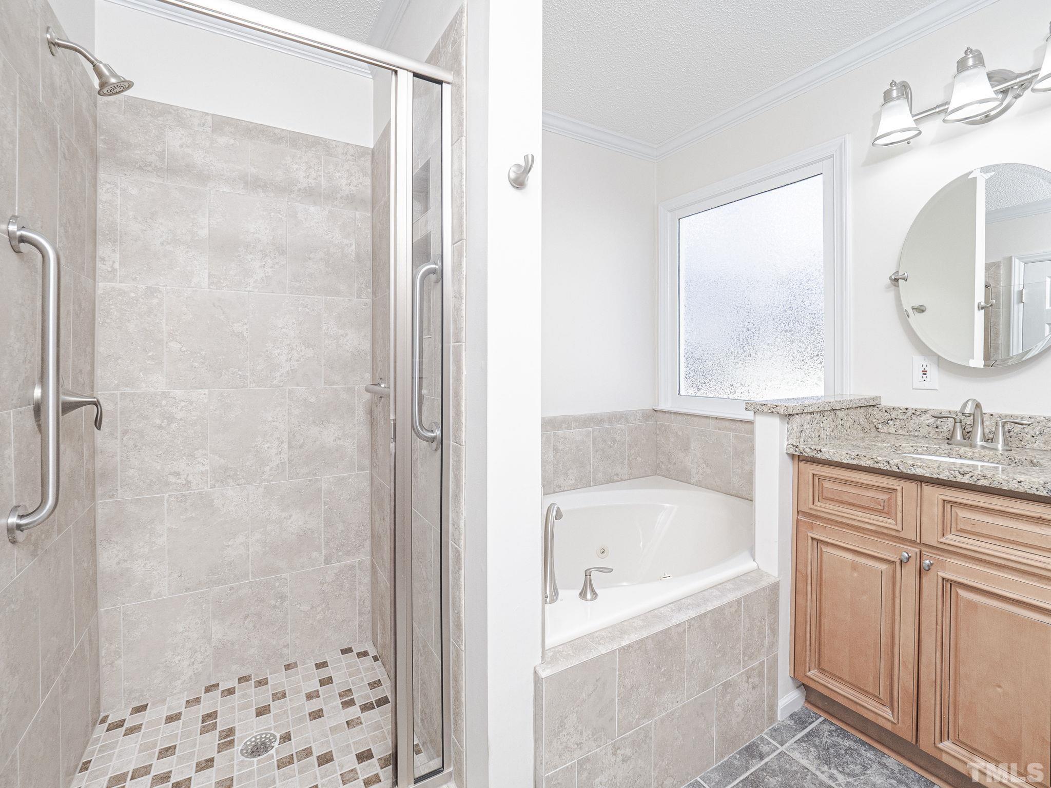 106 Kingsmill Road Cary, NC 27511 - Photo 21 of 31 a bathroom with a bath tub a sink and a mirror