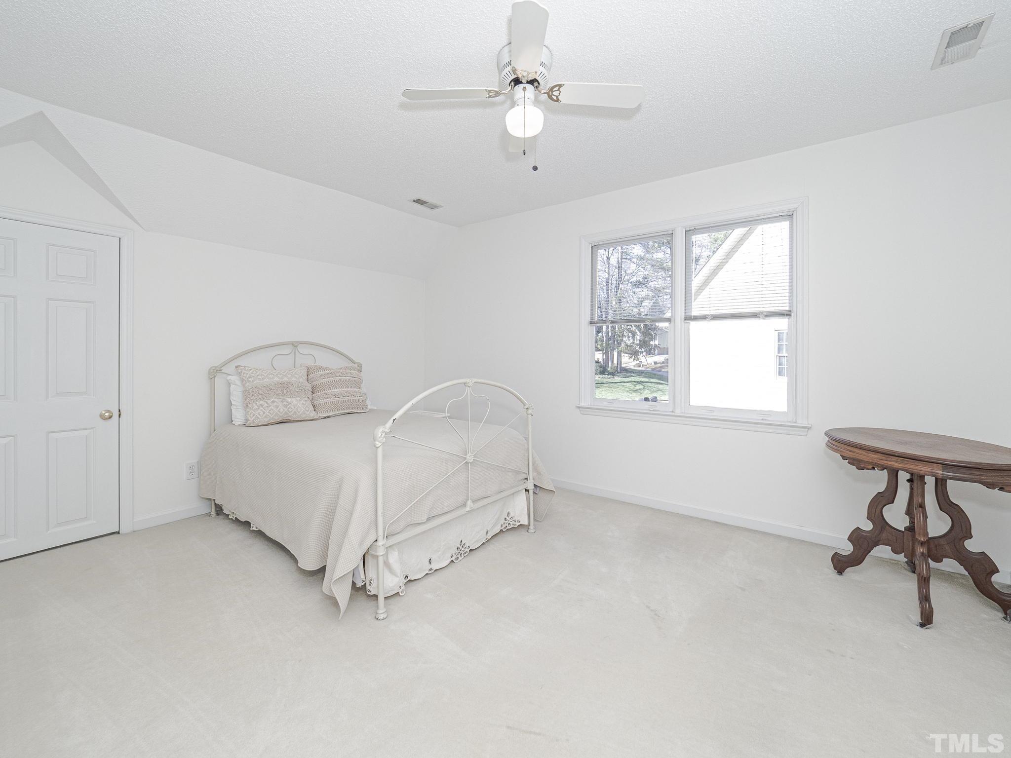 106 Kingsmill Road Cary, NC 27511 - Photo 22 of 31 a bed room with a bed and a window