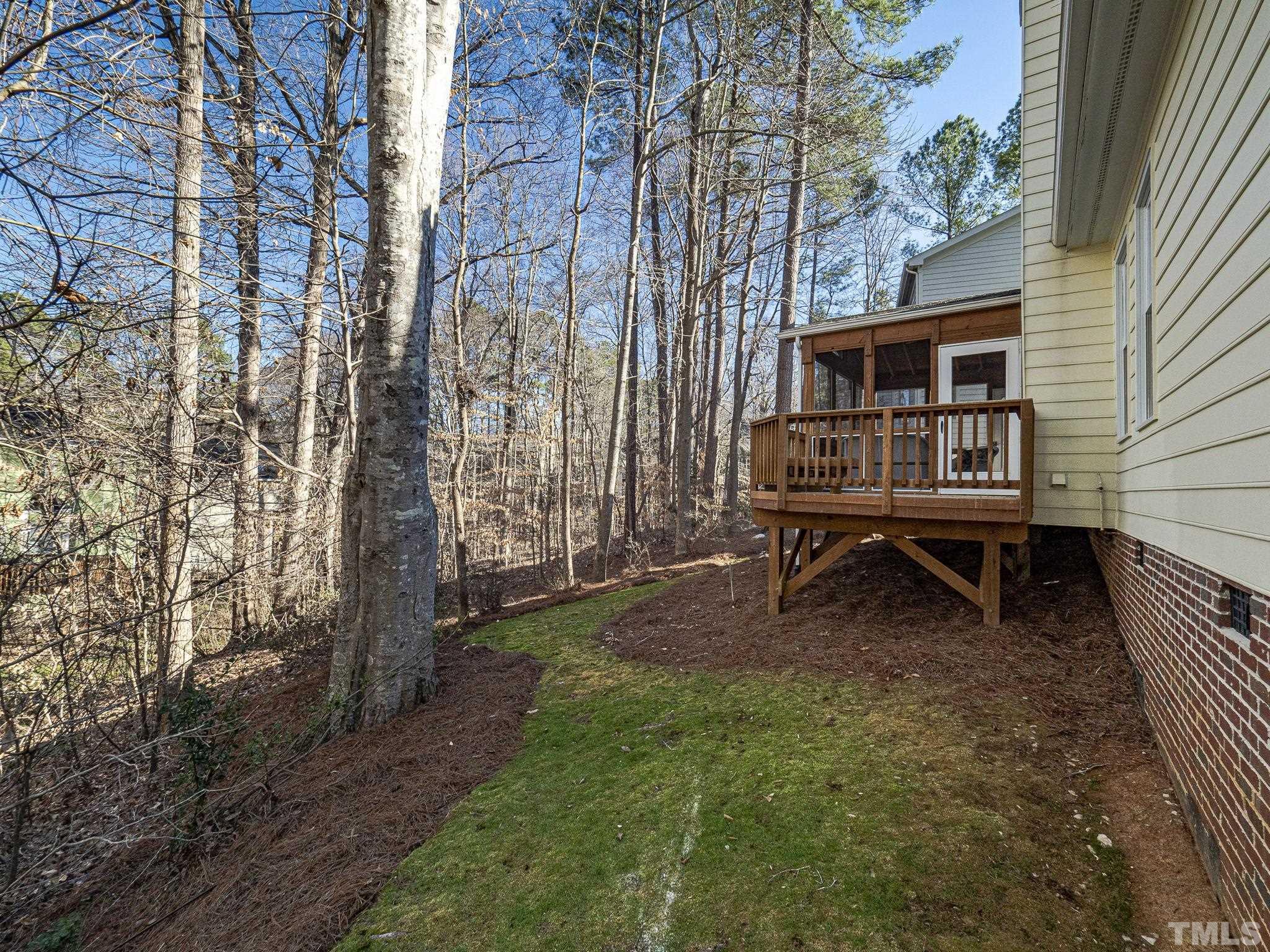 106 Kingsmill Road Cary, NC 27511 - Photo 29 of 31 a wooden bench sitting in front of a building