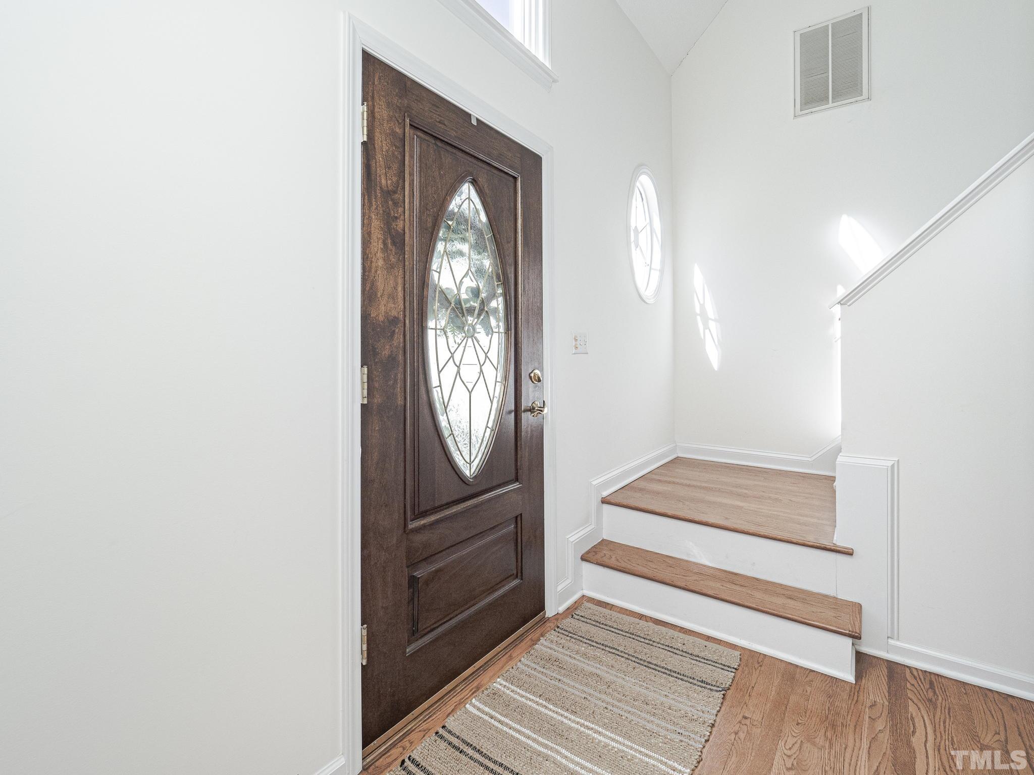 106 Kingsmill Road Cary, NC 27511 - Photo 4 of 31 a view of front door with wooden floor