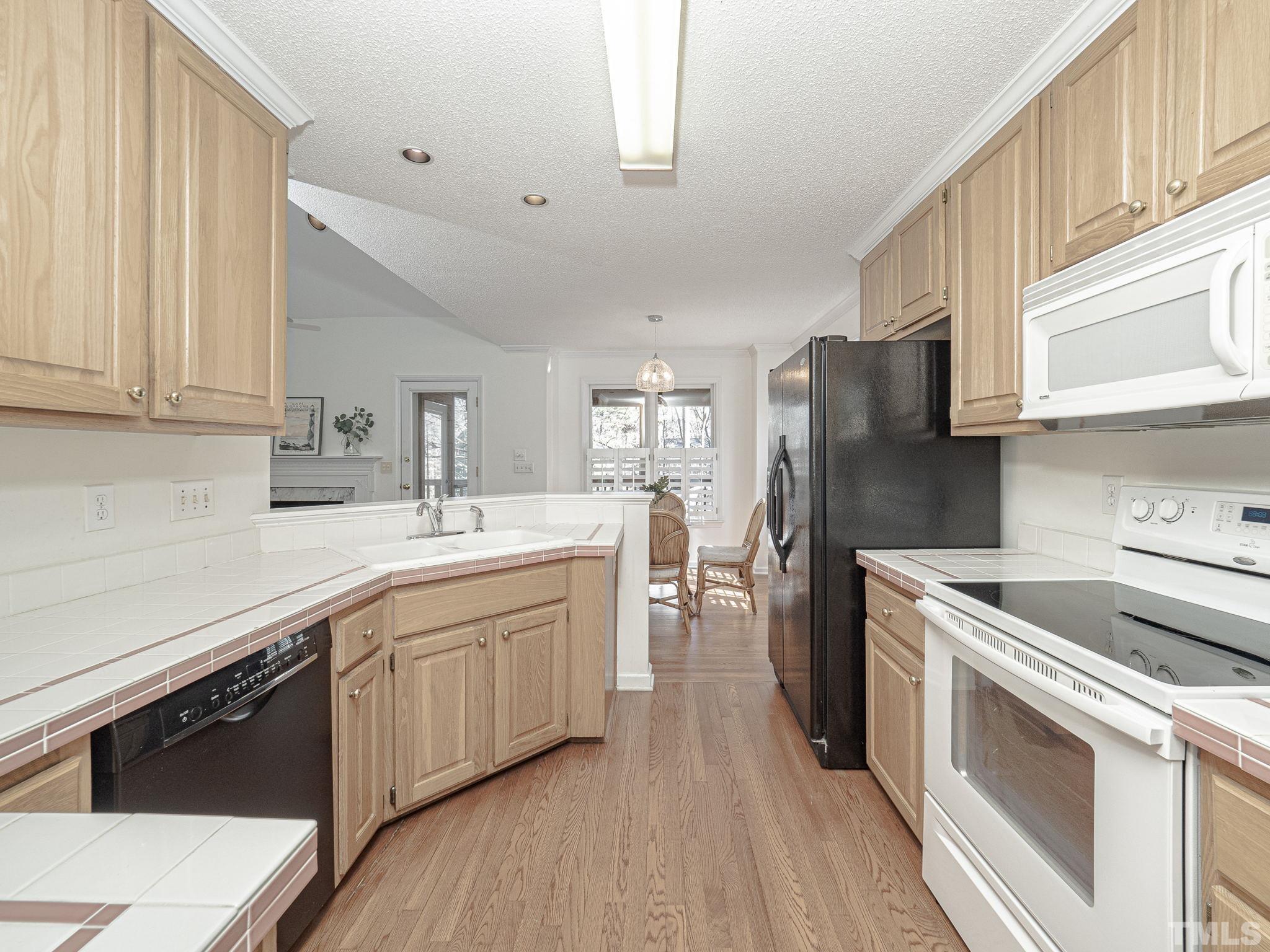 106 Kingsmill Road Cary, NC 27511 - Photo 6 of 31 a kitchen with a sink cabinets stainless steel appliances and a window