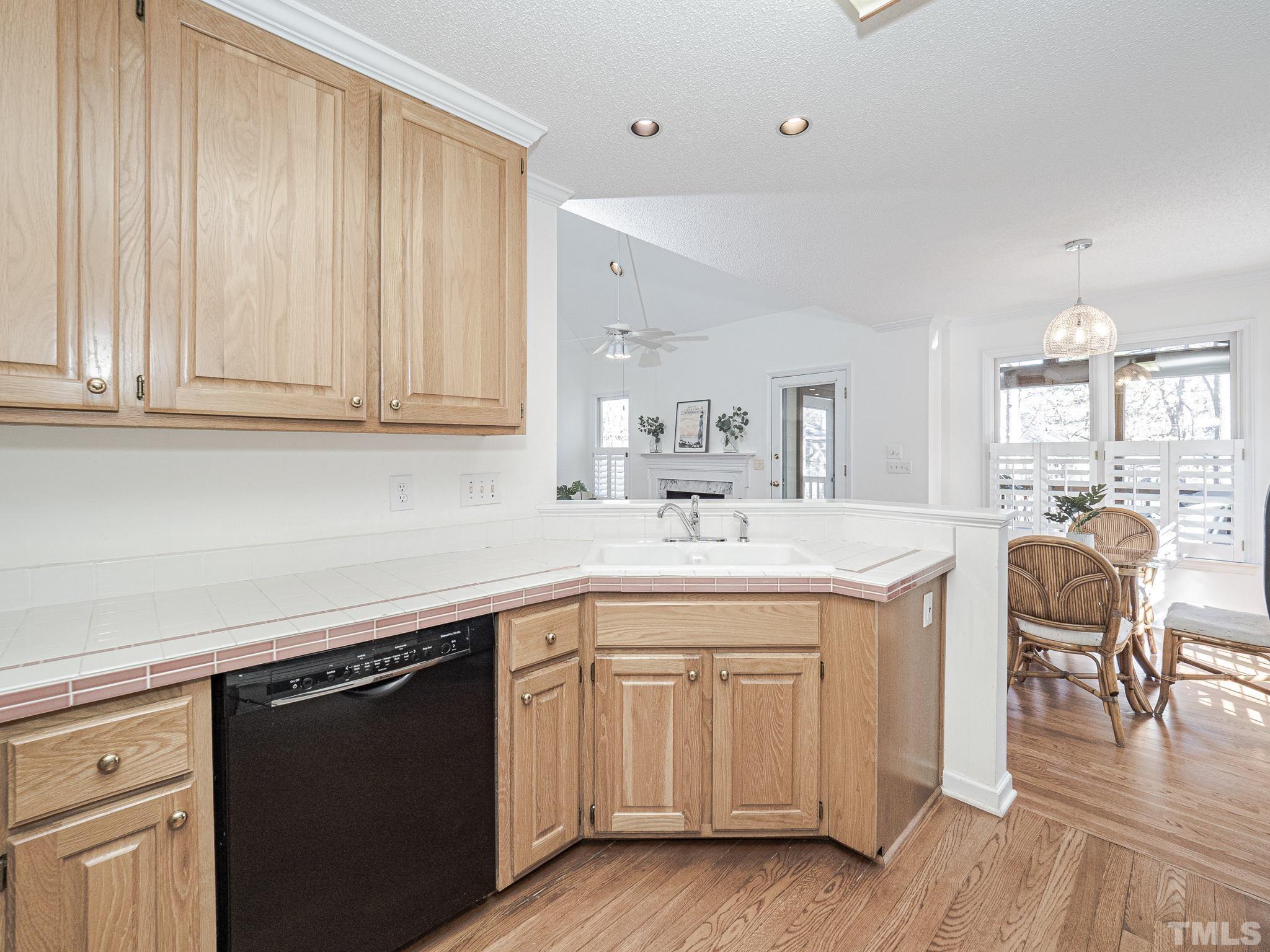106 Kingsmill Road Cary, NC 27511 - Photo 7 of 31 a kitchen with a sink cabinets and wooden floor