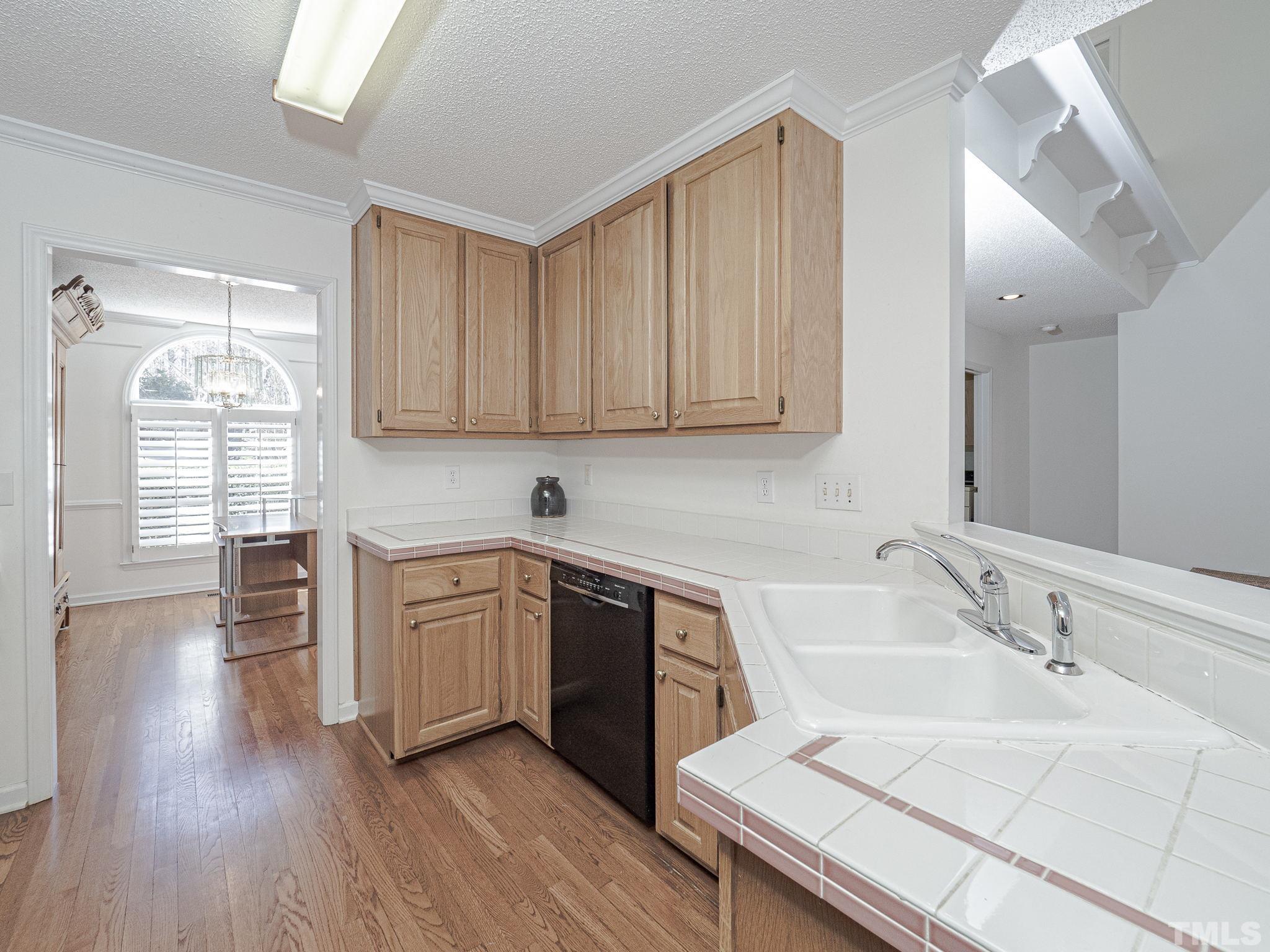 106 Kingsmill Road Cary, NC 27511 - Photo 8 of 31 a kitchen with sink stove and cabinets