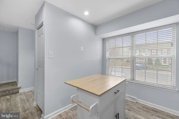 a view of kitchen with a sink and wooden floor