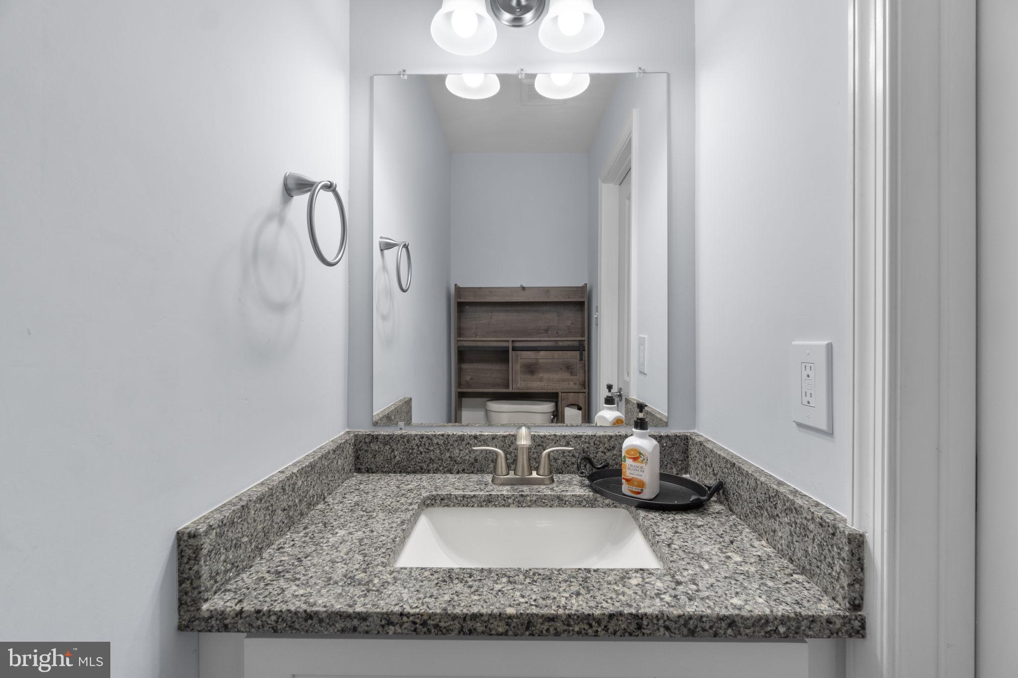 930 Gaming Square Hampstead, MD 21074 - Photo 13 of 36 a bathroom with a granite countertop sink and a mirror