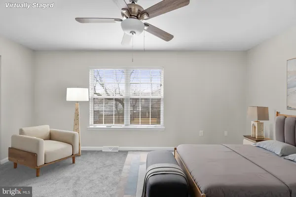 a bedroom with a bed couch and window