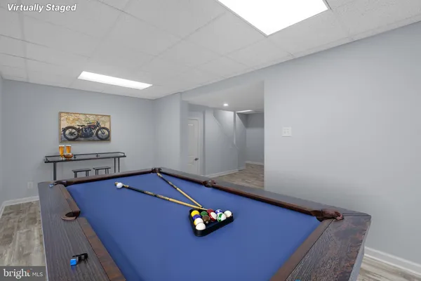 a living room with furniture and wall paintings