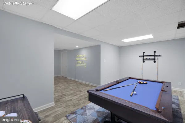 a room with pool table and a window