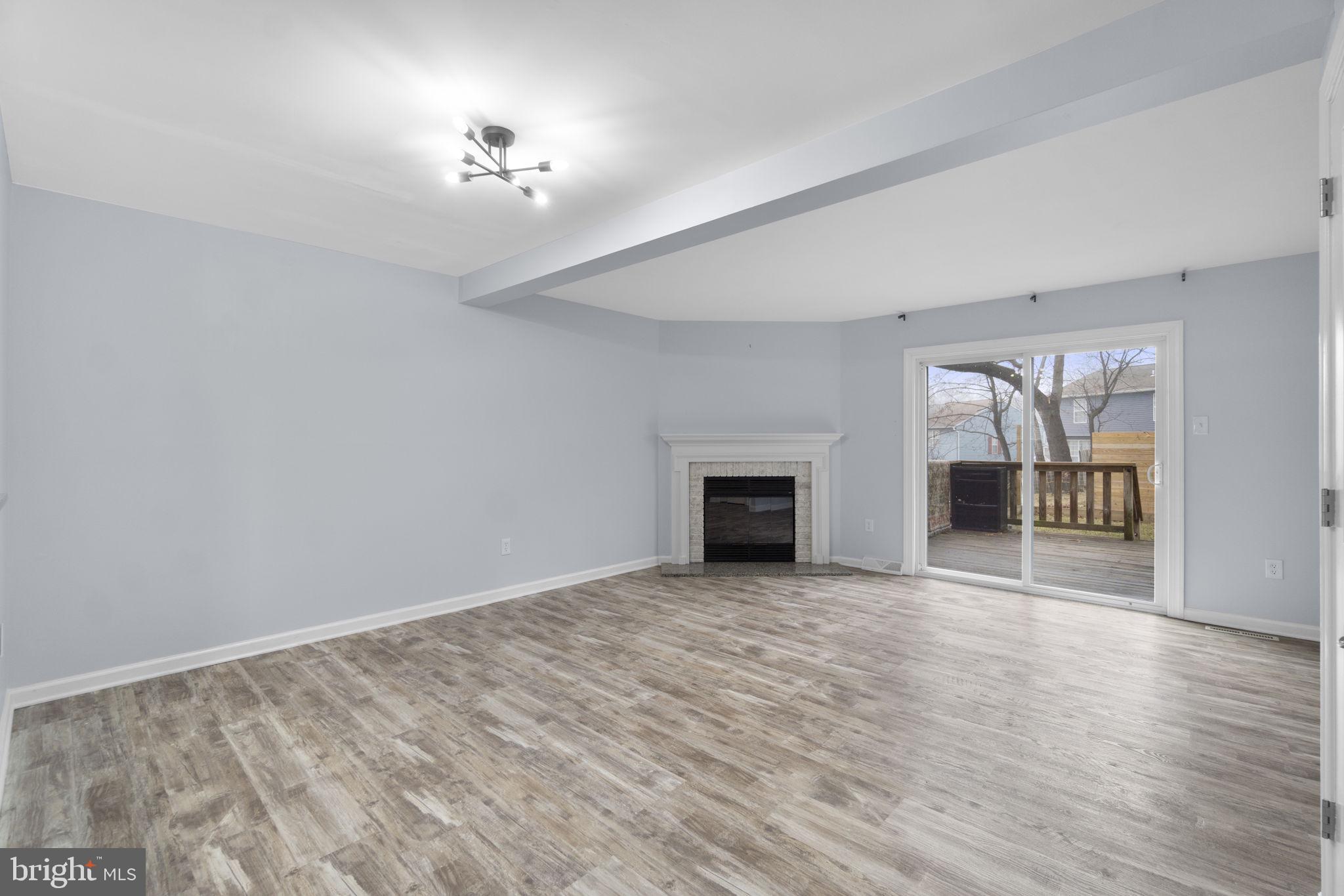930 Gaming Square Hampstead, MD 21074 - Photo 4 of 36 a view of an empty room with a fireplace and a window