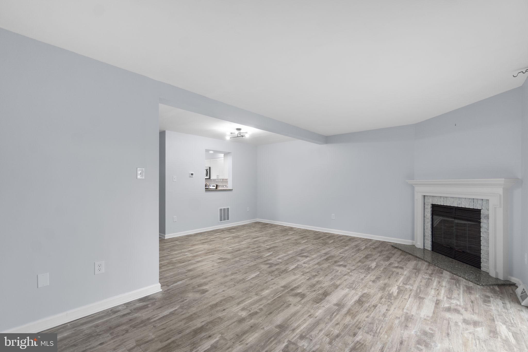 930 Gaming Square Hampstead, MD 21074 - Photo 8 of 36 a view of empty room with wooden floor and fireplace