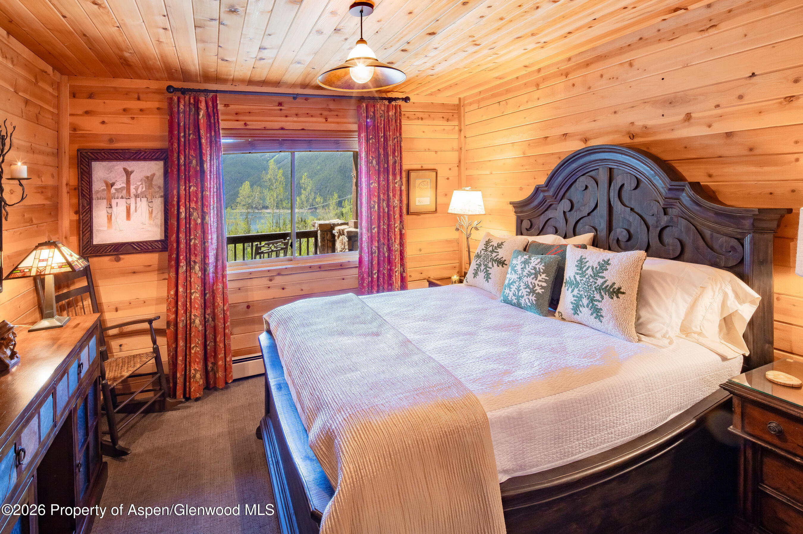 294 Ruedi Creek Road Basalt, CO 81621 - Photo 6 of 27 a bedroom with a bed and a chandelier