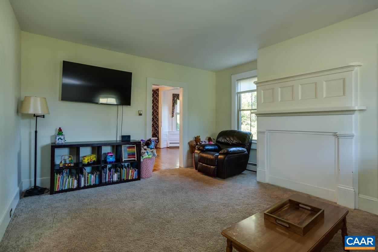 5407 South Blue Ridge Turnpike Rochelle, VA 22738 - Photo 13 of 72 a living room with furniture and a flat screen tv