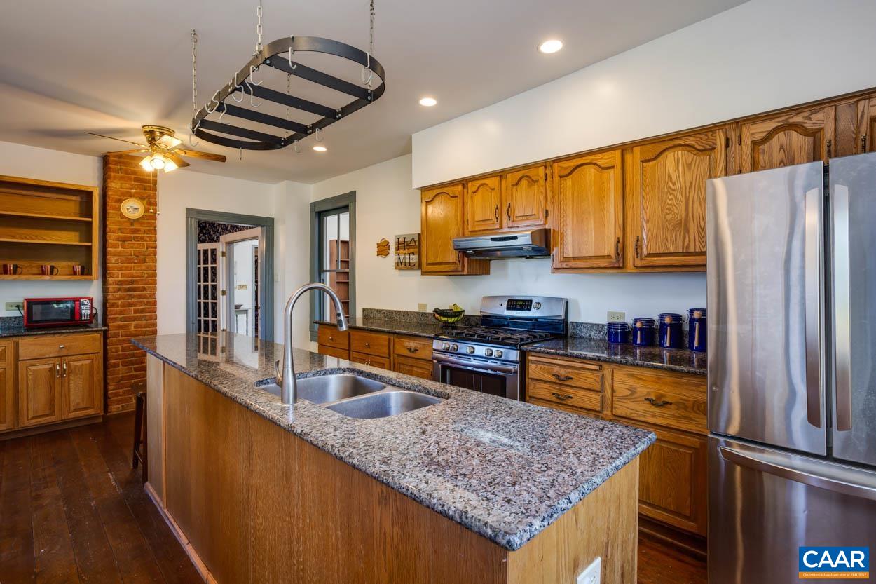 5407 South Blue Ridge Turnpike Rochelle, VA 22738 - Photo 32 of 72 a kitchen with stainless steel appliances granite countertop a refrigerator a sink and a stove