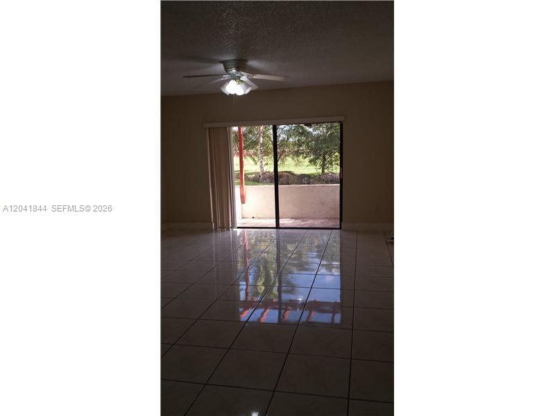 8610 Southwest 149th Avenue, Unit 504 Miami, FL 33193 - Photo 5 of 13 a picture of a room with a floor to ceiling window