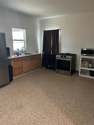 a kitchen with a refrigerator and a sink