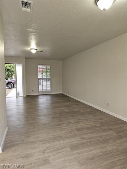 3005 Gordon Street Naples, FL 34112 - Photo 3 of 11 Empty room with light wood-style floors and baseboards