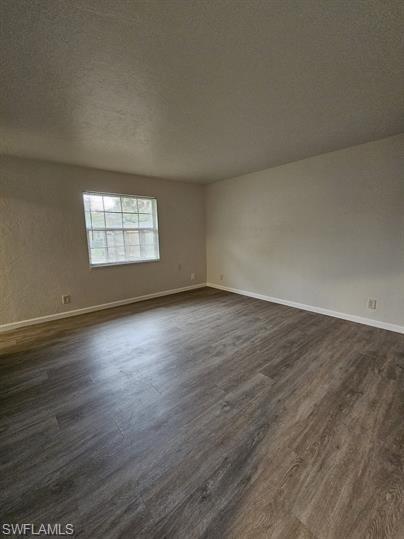 3005 Gordon Street Naples, FL 34112 - Photo 5 of 11 Spare room with dark wood finished floors and a textured ceiling