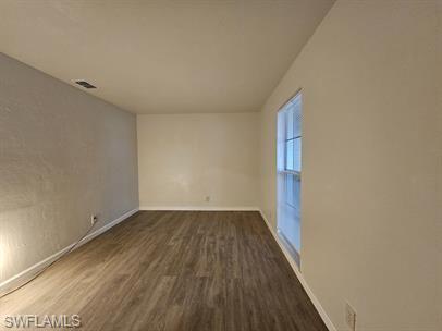 3005 Gordon Street Naples, FL 34112 - Photo 7 of 11 Spare room featuring dark wood-style floors and baseboards