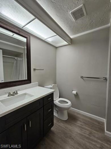 3005 Gordon Street Naples, FL 34112 - Photo 8 of 11 Bathroom featuring vanity, curtained shower, dark wood finished floors, and a textured ceiling